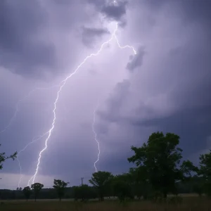 Dark stormy sky with lightning and trees swaying in wind