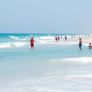 Lifeguards monitoring the beach with beachgoers enjoying the sun.
