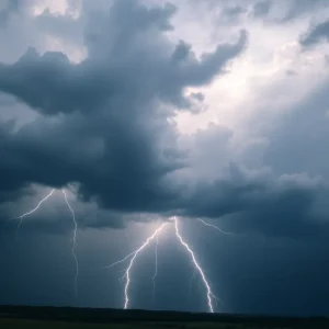 Dark storm clouds with lightning illuminating the sky