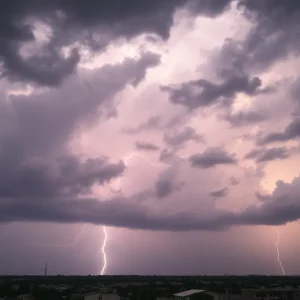 Dramatic thunderstorm clouds with lightning over a city landscape