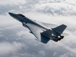 YFQ-42A Collaborative Combat Aircraft flying in the sky demonstrating advanced technology.