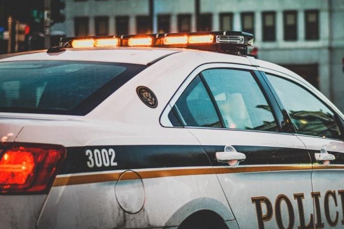 Police cruiser parked beside a roadway