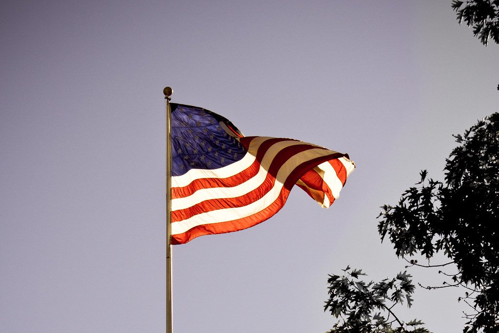 American flag flying against a blue sky